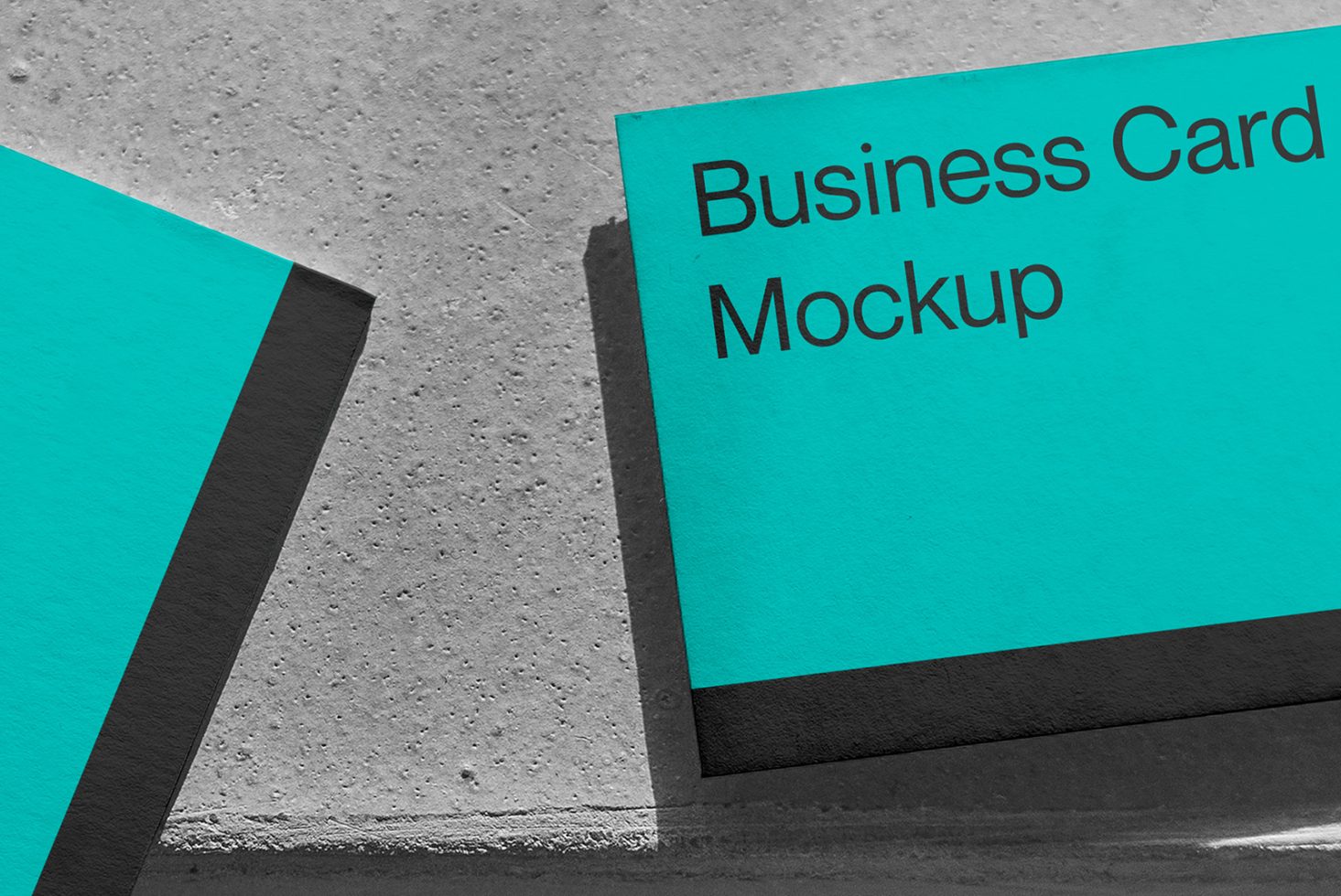 Professional business card mockup in teal and black with a textured background for graphic designers.